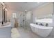 Luxurious bathroom with soaking tub, separate shower, and double vanity at 943 N 97Th Way, Mesa, AZ 85207