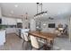 Modern kitchen with island and breakfast bar, open to dining area at 943 N 97Th Way, Mesa, AZ 85207