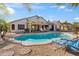 Inviting kidney-shaped pool with lounge chairs in a desert landscape at 9620 W Ruth Ave, Peoria, AZ 85345