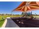 Community playground with shaded play structures at 10719 E Lupine Ln, Florence, AZ 85132