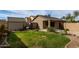 Full backyard view with lush lawn, storage shed, and covered patio area at 125 W Welsh Black Cir, San Tan Valley, AZ 85143