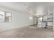 Open living room with carpeted floors, ceiling fan, and view of the kitchen at 125 W Welsh Black Cir, San Tan Valley, AZ 85143