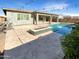 Expansive backyard with a sparkling pool and fire pit at 14139 W Gray Fox Trl, Surprise, AZ 85387