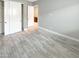 Spacious bedroom with double door closet and wood-look tile floor at 14139 W Gray Fox Trl, Surprise, AZ 85387