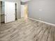 Light and airy bedroom with double door closet and wood-look tile floors at 14139 W Gray Fox Trl, Surprise, AZ 85387