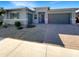 Single-story home with gray exterior, two-car garage, and landscaped front yard at 14139 W Gray Fox Trl, Surprise, AZ 85387