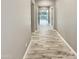 Bright hallway with wood-look floors leading to other rooms at 14139 W Gray Fox Trl, Surprise, AZ 85387