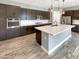 Modern kitchen with dark cabinetry, quartz countertops, and large island at 14139 W Gray Fox Trl, Surprise, AZ 85387