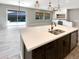Spacious kitchen island with white quartz countertop and dark cabinetry at 14139 W Gray Fox Trl, Surprise, AZ 85387