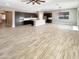 Open concept living room with wood-look tile flooring at 14139 W Gray Fox Trl, Surprise, AZ 85387