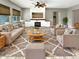 Spacious living room with fireplace, built-in shelving, and large windows at 14139 W Gray Fox Trl, Surprise, AZ 85387