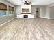 Open living area with hardwood floors and a fireplace at 14139 W Gray Fox Trl, Surprise, AZ 85387