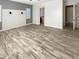 Bright and spacious main bedroom with wood-look floors and access to the bathroom at 14139 W Gray Fox Trl, Surprise, AZ 85387