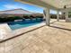 Inviting pool and patio area with covered seating at 14139 W Gray Fox Trl, Surprise, AZ 85387