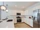 Modern kitchen with white cabinets, stainless steel appliances, and an island at 15875 W Kendall St, Goodyear, AZ 85338