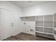 Laundry room with shelving and door at 18412 W Desert Hollow Dr, Surprise, AZ 85387