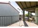 Covered balcony with metal railing and partial view of parking lot at 2315 W Union Hills Dr # 116, Phoenix, AZ 85027