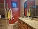 Bathroom with granite countertop, shower, and red walls at 2687 E Caitlin Way, San Tan Valley, AZ 85140