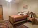 Bedroom with wooden bed frame, nightstand, and southwestern decor at 2687 E Caitlin Way, San Tan Valley, AZ 85140