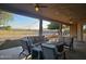 Covered patio with seating area and fire pit at 2687 E Caitlin Way, San Tan Valley, AZ 85140