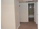 Hallway with neutral walls and carpeting, leading to bathroom at 3434 W Danbury Dr # A204, Phoenix, AZ 85053