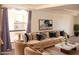 Living room with beige couch and marble-top coffee table at 3434 W Danbury Dr # A204, Phoenix, AZ 85053