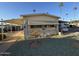 Single-wide manufactured home with carport and landscaped yard at 4065 E University Dr # 276, Mesa, AZ 85205