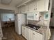 Galley kitchen with white cabinets and granite countertops at 4065 E University Dr # 276, Mesa, AZ 85205