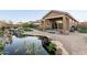 Landscaped backyard oasis with pond and patio area at 4443 N 94Th Dr, Phoenix, AZ 85037