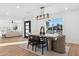 Bright dining room with modern light fixture and view to living room at 5030 E Winchcomb Dr, Scottsdale, AZ 85254