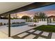 Tranquil evening view of a modern pool and patio area at 5030 E Winchcomb Dr, Scottsdale, AZ 85254