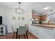 Dining area with glass table and kitchen view at 5704 E Aire Libre Ave # 1210, Scottsdale, AZ 85254