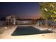 Swimming pool in backyard at dusk with shed visible at 655 W Caroline St, Coolidge, AZ 85128