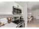 Kitchen with stainless steel range, microwave, and white cabinetry at 664 W Viola St, Casa Grande, AZ 85122