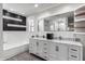 Elegant bathroom with double vanity, marble countertop and a soaking tub at 6643 E Vernon Ave, Scottsdale, AZ 85257