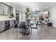 Modern dining area with glass table and black chairs, open to living area and kitchen at 6643 E Vernon Ave, Scottsdale, AZ 85257