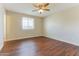 Bright bedroom with hardwood floors and large window at 707 N 92Nd Pl, Mesa, AZ 85207