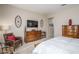 Bedroom with wood dresser, TV, and comfortable seating at 7103 W Turnstone Dr, Florence, AZ 85132