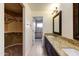 Bathroom with granite countertops, double sinks, and walk-in closet at 8653 E Royal Palm Rd # 2005, Scottsdale, AZ 85258