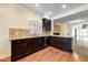 Modern kitchen with granite countertops and dark wood cabinets at 8653 E Royal Palm Rd # 2005, Scottsdale, AZ 85258