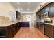 Modern kitchen with granite countertops, stainless steel appliances, and dark wood cabinets at 8653 E Royal Palm Rd # 2005, Scottsdale, AZ 85258