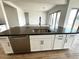 Modern kitchen island with stainless steel sink and dark countertops at 11512 E Utah Ave, Mesa, AZ 85212