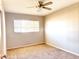 Bright bedroom with ceiling fan and carpet flooring at 1311 E 2Nd Pl, Mesa, AZ 85203