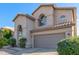 Two-story house with a two-car garage and mature shrubs at 1325 E Sheena Dr, Phoenix, AZ 85022