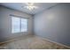 Well-lit bedroom with window, ceiling fan and neutral decor at 15668 W Devonshire Ave, Goodyear, AZ 85395