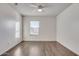 Bright bedroom featuring wood-look floors and a ceiling fan at 165 W Taylor Ave, Coolidge, AZ 85128