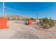 Entrance to a property with red wall and open gate at 2286 W Moon Vista St, Apache Junction, AZ 85120