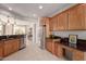 Modern kitchen with wood cabinets, granite countertops, and stainless steel appliances at 26167 W Firehawk Dr, Buckeye, AZ 85396