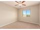 Well lit bedroom with a ceiling fan and a window at 28109 N Raelynn Ln, Queen Creek, AZ 85144