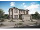 Two-story house with stone accents and a three-car garage at 34504 N Timberlake Mnr, San Tan Valley, AZ 85144